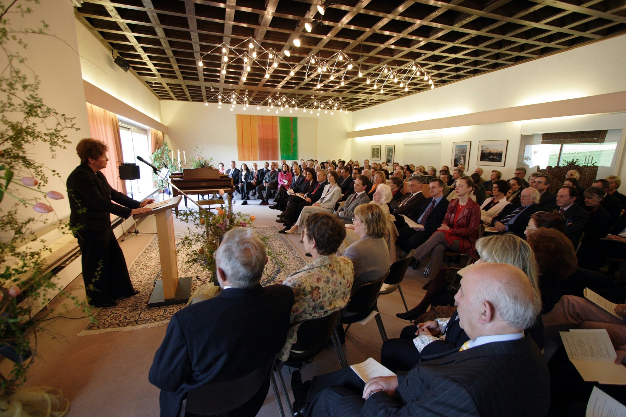 Guests and Baha'is at the centenary reception at Langehain listen the representative of the city of Wiesbaden,Angelika Thiels, who thanked the Baha'i community for nurturing understanding among religions.