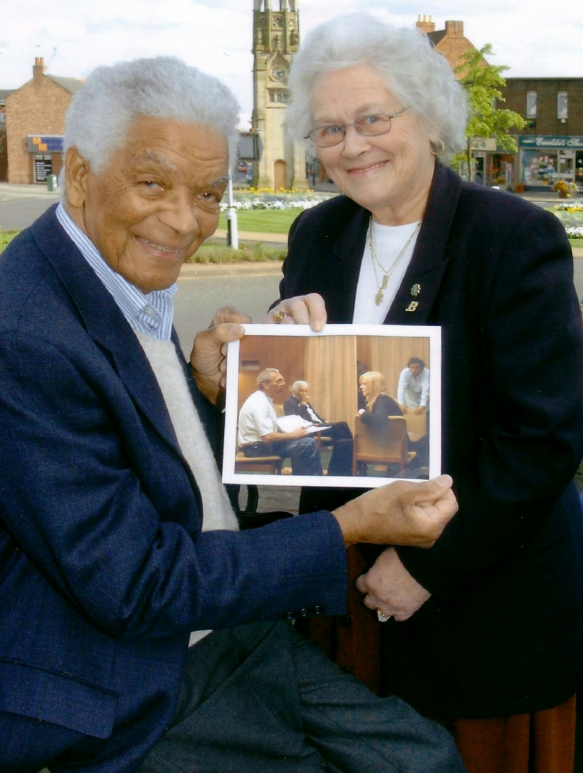 Actor Earl Cameron and his wife, Barbara, with a photograph taken on the set of "The Interpreter." Photo courtesy of Kenilworth Weekly News.