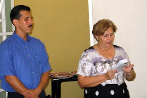 The chief of religious affairs in the Cuban government, Caridad Diego Bello, addresses the interreligious gathering held at the national Baha'i center on 23 May 2005. At left is the secretary of the Local Spiritual Assembly of the Baha'is of Havana, Ernesto Santirso.