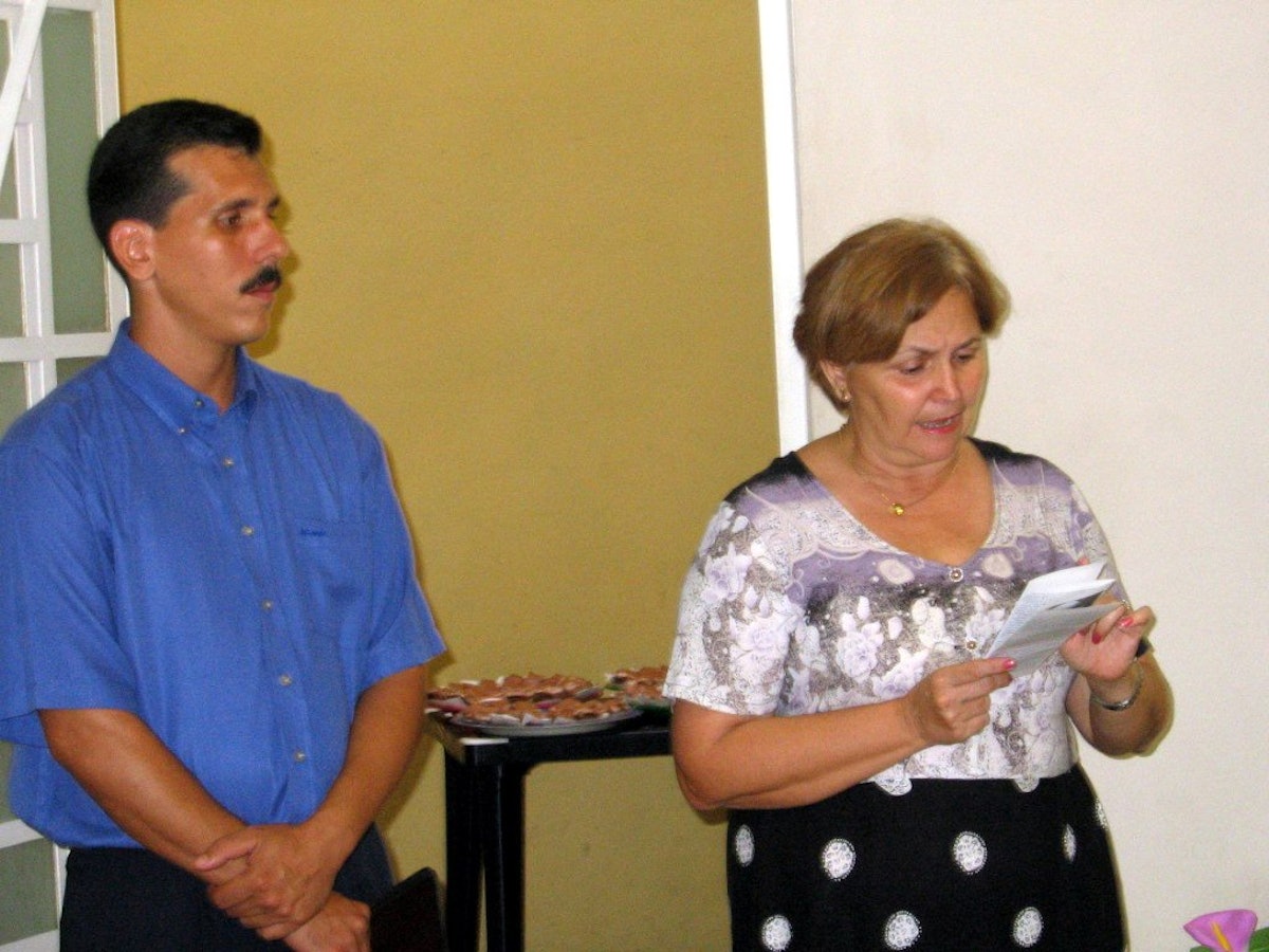 The chief of religious affairs in the Cuban government, Caridad Diego Bello, addresses the interreligious gathering held at the national Baha'i center on 23 May 2005. At left is the secretary of the Local Spiritual Assembly of the Baha'is of Havana, Ernesto Santirso.