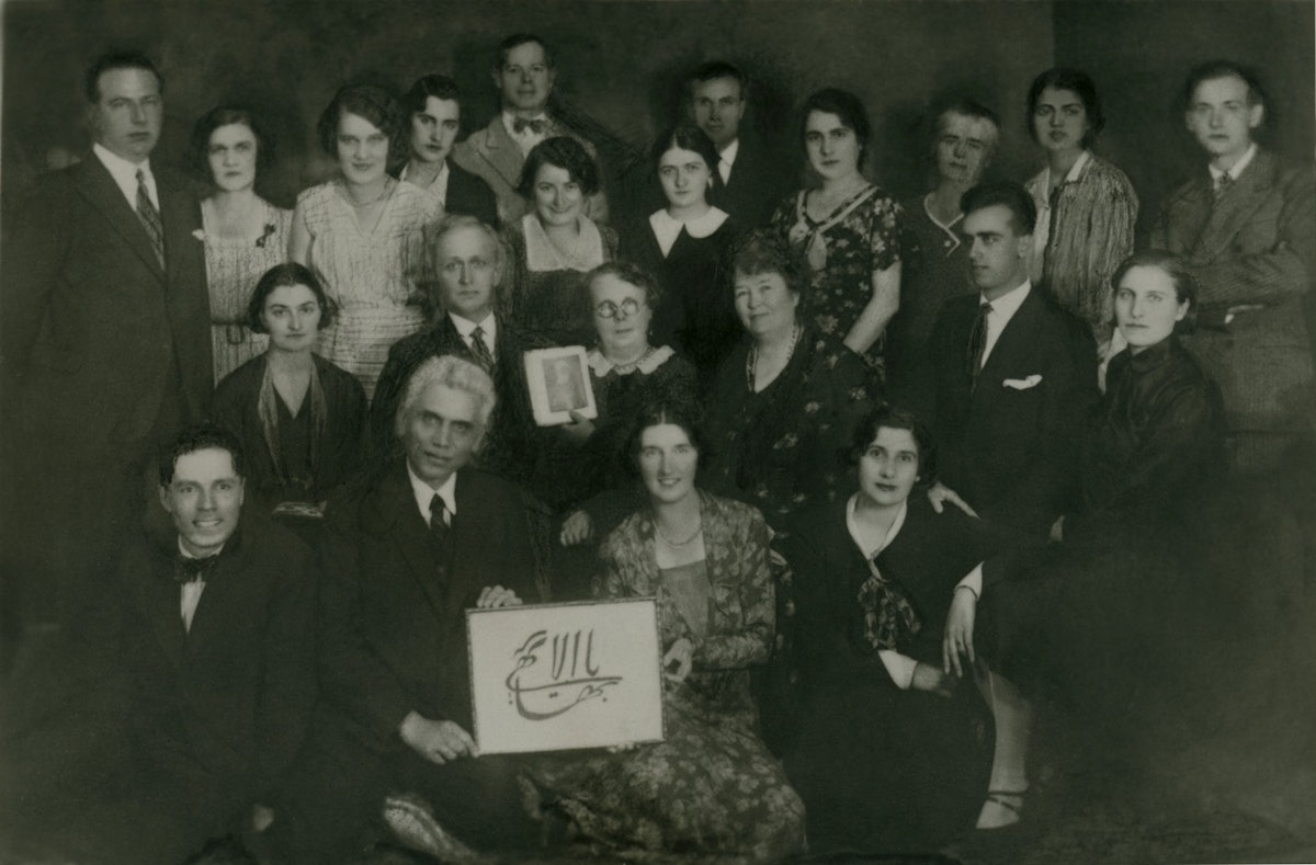 Baha'is of Sofia, 1932. Marion Jack is seated fourth from left in the second row, next to Lina Benke, who, with her husband, George Adam Benke, is holding a photograph of 'Abdu'l-Baha. Two Baha'is in the front row are displaying a representation in calligraphy of Baha'ullah's name.