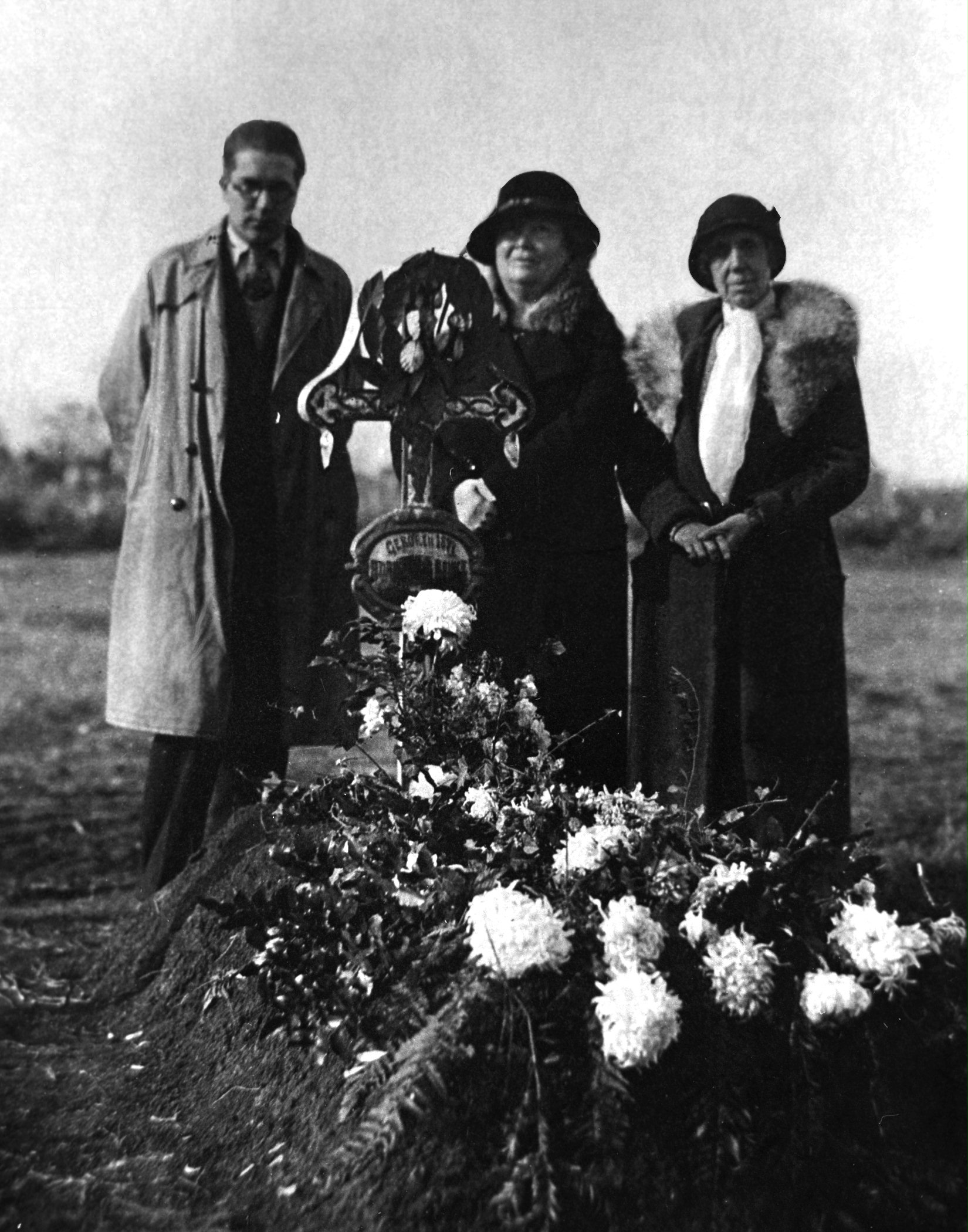 At the grave of George Adam Benke in 1932...Hand of the Cause of God Martha Root (1872-1939), right, Marion Jack (center), and an unknown mourner.