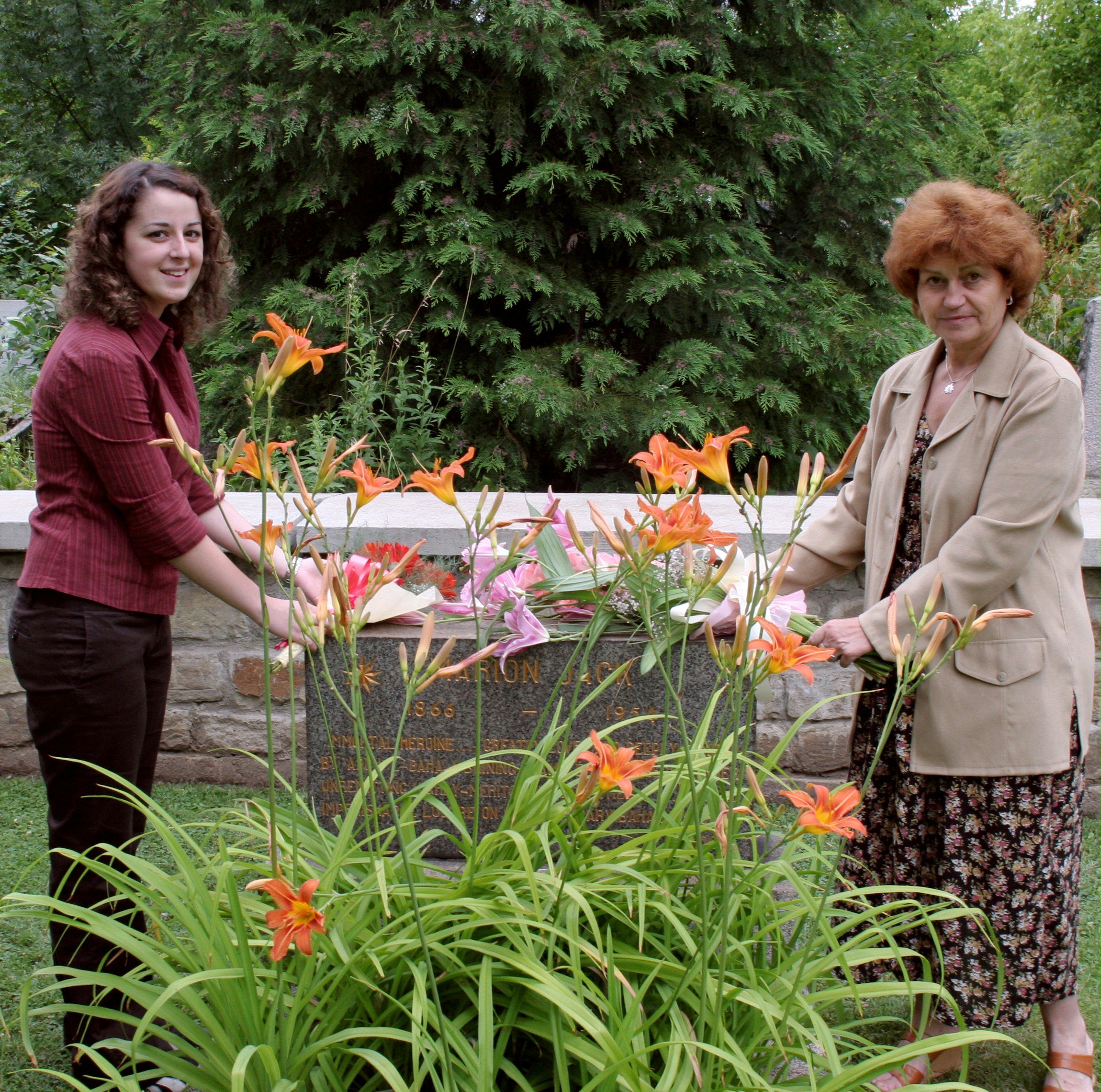 Bouquets for a heroine... Stana Radoslavova, the chairman of the National Spiritual Assembly of the Baha'is of Bulgaria (right), and Melody Donnelly, a member of the Plovdiv Baha'i community, place flowers at the resting place of Baha'i pioneer Marion Jack.