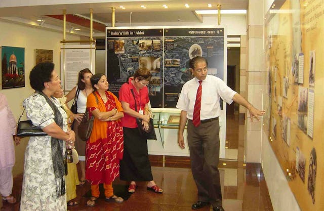 In the Information Centre of the Baha'i House of Worship in India, the First Lady of Fiji, Leba Qarase (left) listened to an explanation of a display by Shatrughun Jiwnani, the Temple's public relations general manager (right).