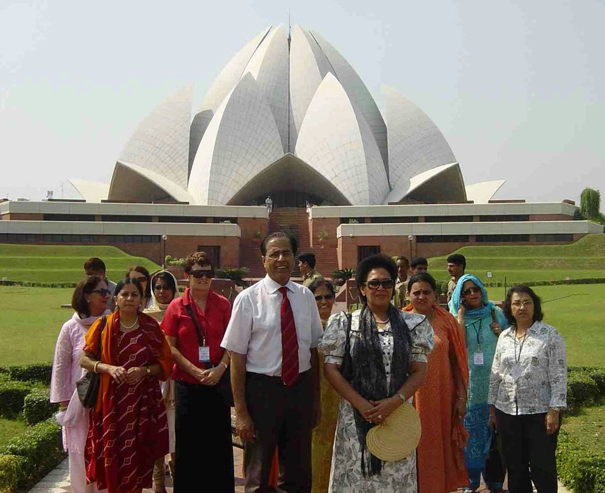 The First Lady of Fiji, Leba Qarase (at front with hat) and her entourage visiting the Baha'i House of Worship in New Delhi. Escorting the visitors was Shatrughun Jiwnani, the Temple's public relations general manager (in white shirt and tie).