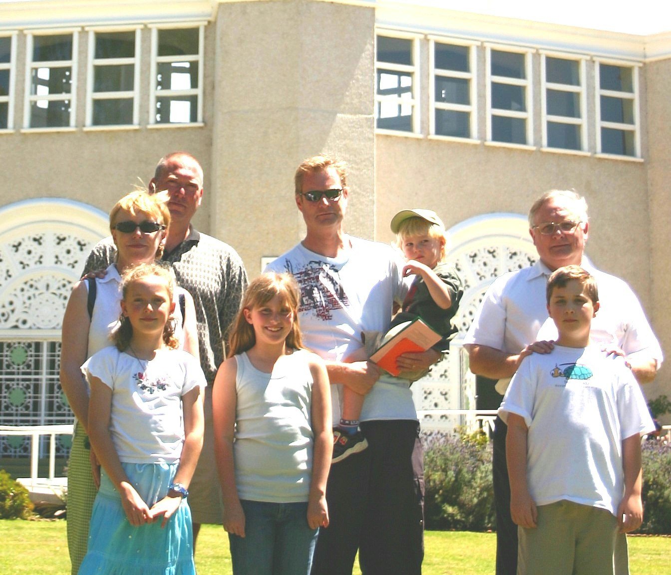 Some of the children who read at the devotional service in the Baha'i Temple in Sydney (background): (front row, left to right) Morgan Smoot, Holly Waters, Daniel Dickinson. Among the family members in the back row are Jack Smoot (second from left), and Alan Dickinson (right).