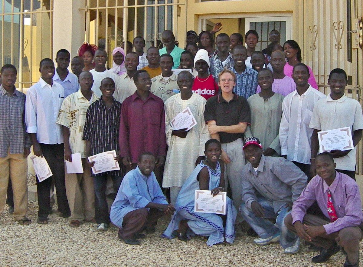 Some participants in the advanced computer class offered by the Baha'is of The Gambia are holding their graduation certificates. The teacher, Eric Michell, is in the second row, fourth from right.