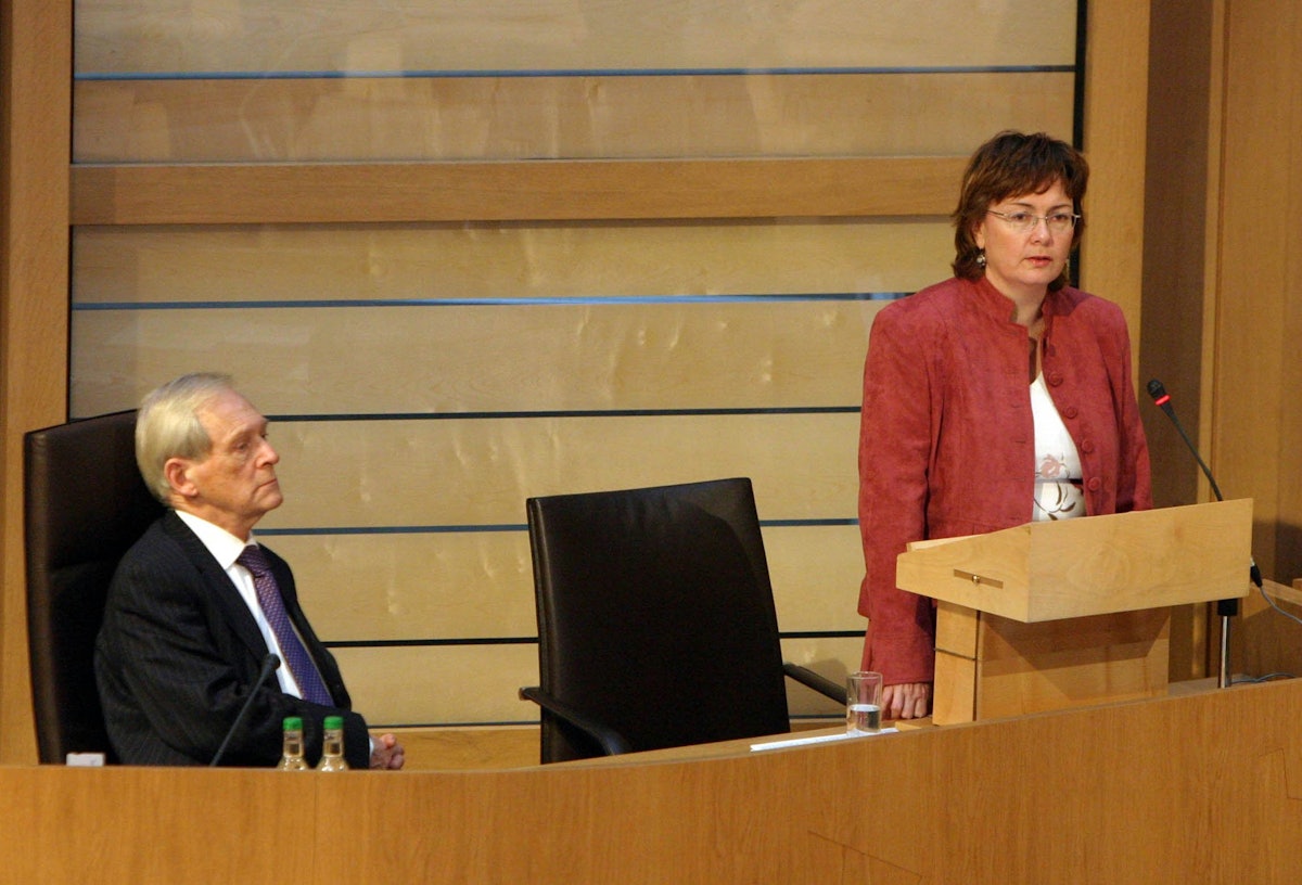 The Presiding Officer of the Scottish Parliament, the Right Honorable George Reid MSP, left, listens to Ms. Carrie Varjavandi of the Scottish Baha'i Community give her "Time for Reflection" address on 18 January 2006. (Photograph courtesy of and copyright by Scottish Parliamentary Corporate Body 2005.)
