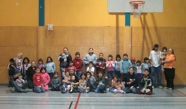 Some of the children and parents who attend the Family Virtues Breakfast posed recently in the gym of the community center where the program takes place.