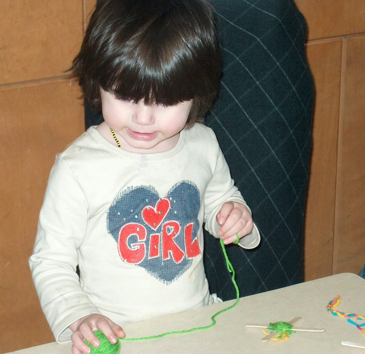 Jordan weaves a "God's eye" at the crafts table during the Family Virtues Breakfast in Winnipeg.