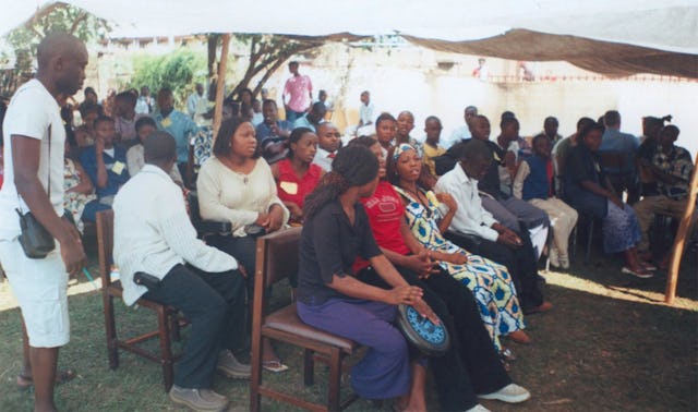 Conference participants join in a discussion during a plenary session.