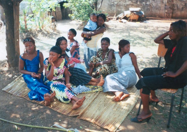 Youth from different countries enjoy each other's company during a lunch break.