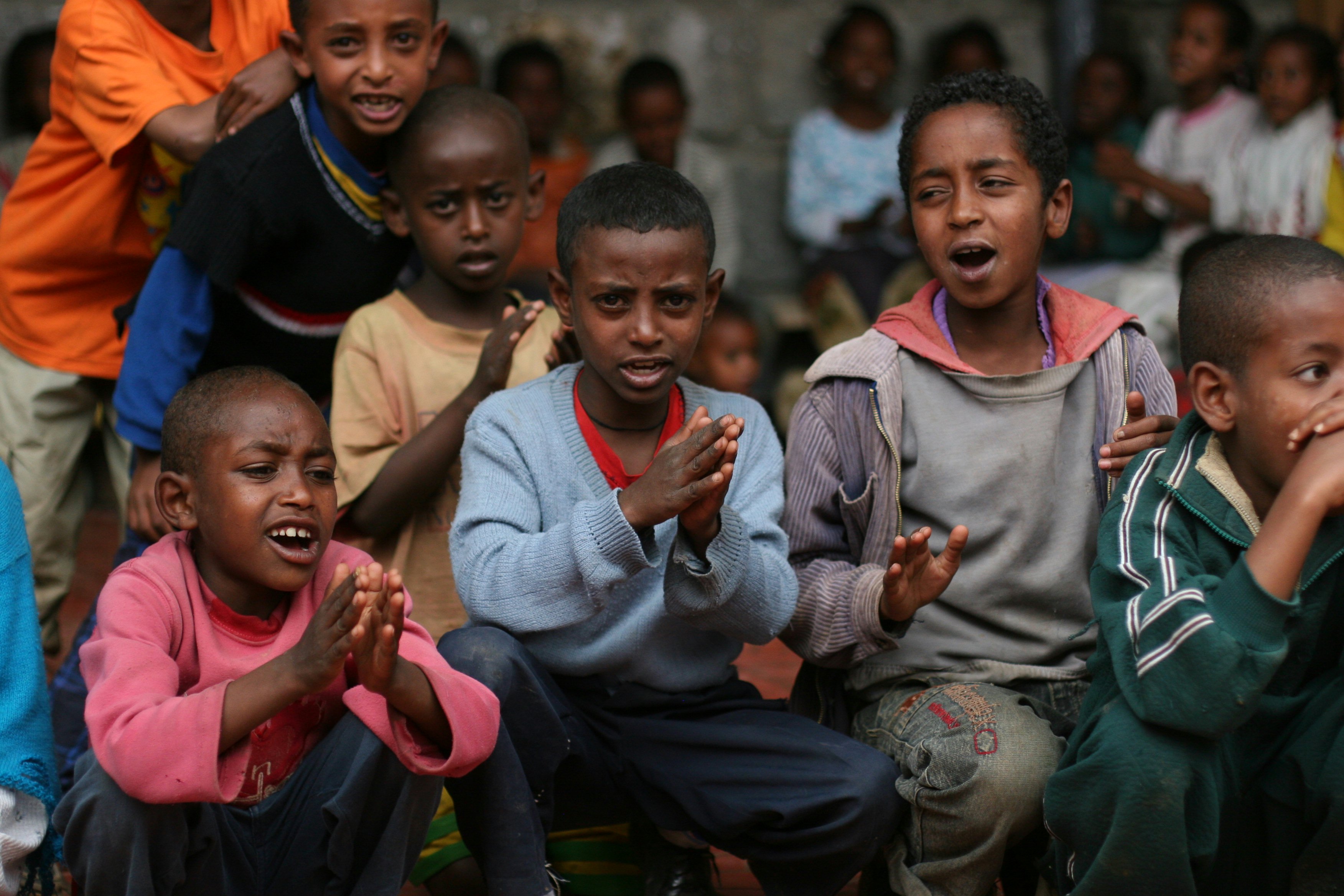 The children practice a song they will sing at a concert for their parents. (Photograph by Ryan Lash)