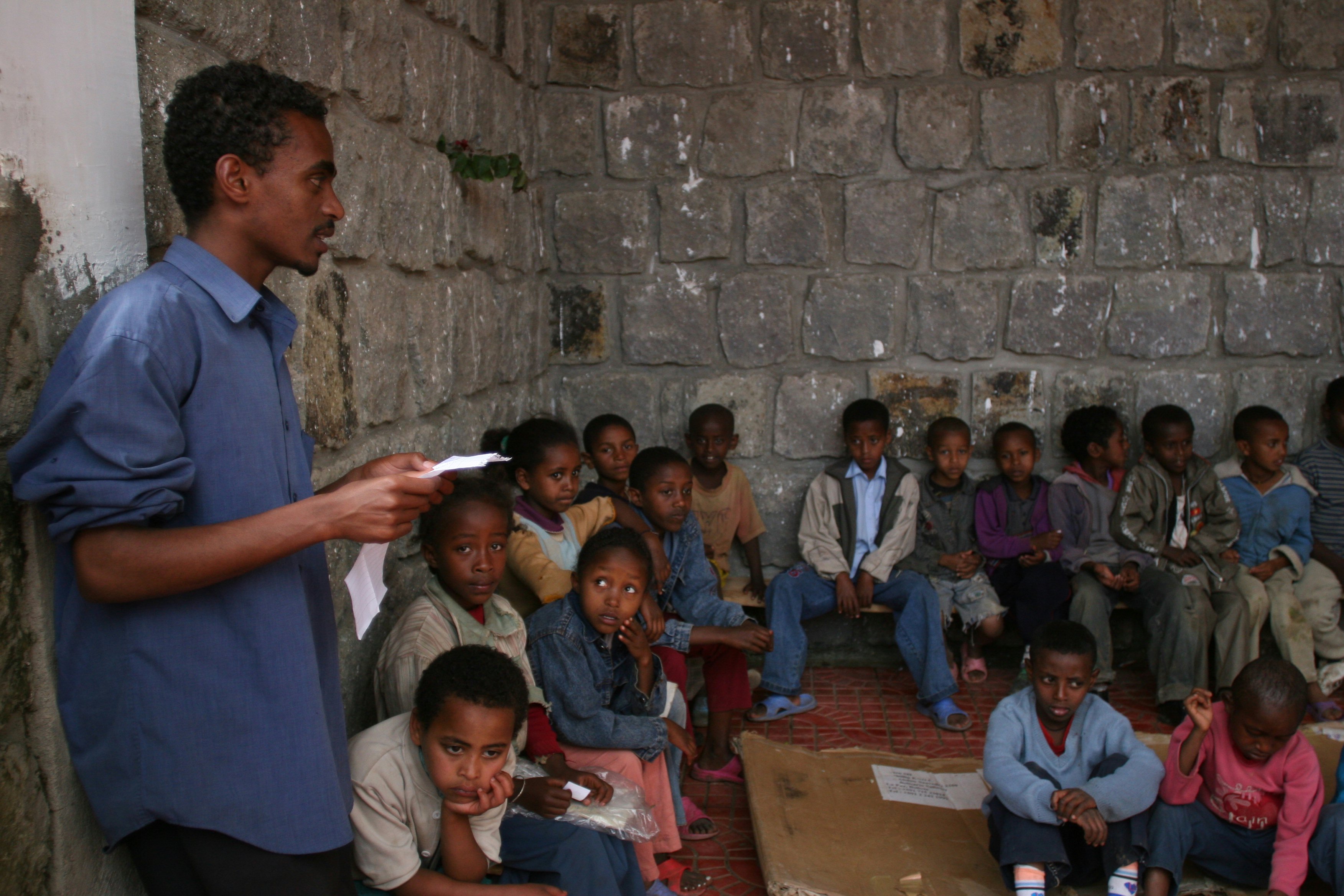 The teacher explains a concept to the children. (Photograph by Ryan Lash)