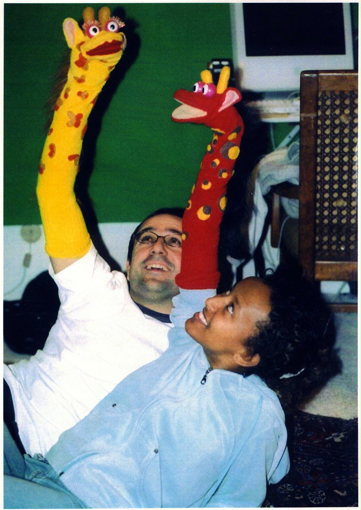 The Etzenhousers film a scene where the puppets are having a discussion.