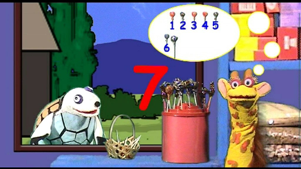 Tsehai practices her numbers as Mr. Turtle looks on.