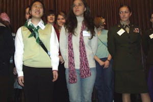 Anisa Andrade de Araujo (foreground, in jeans) of Brazil joins other delegates on the stage at the meeting of the U.N. Commission on the Status of Women.