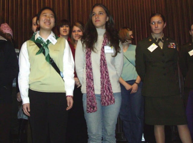 Anisa Andrade de Araujo (foreground, in jeans) of Brazil joins other delegates on the stage at the meeting of the U.N. Commission on the Status of Women.