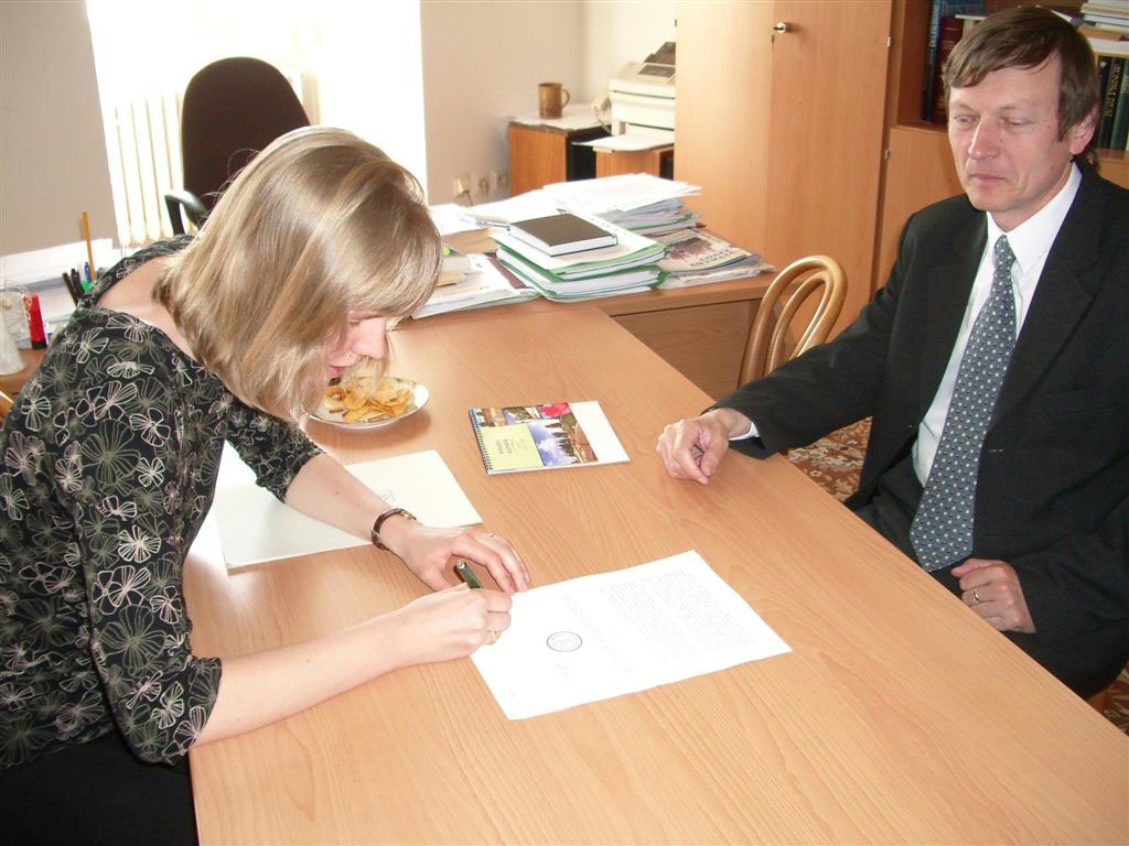 Baha'i representative Jitka Spillerova signs documents for the Baha'i application for state recognition. At right is Jan Juran of the Ministry of Culture. The signing took place on 19 April 2007.