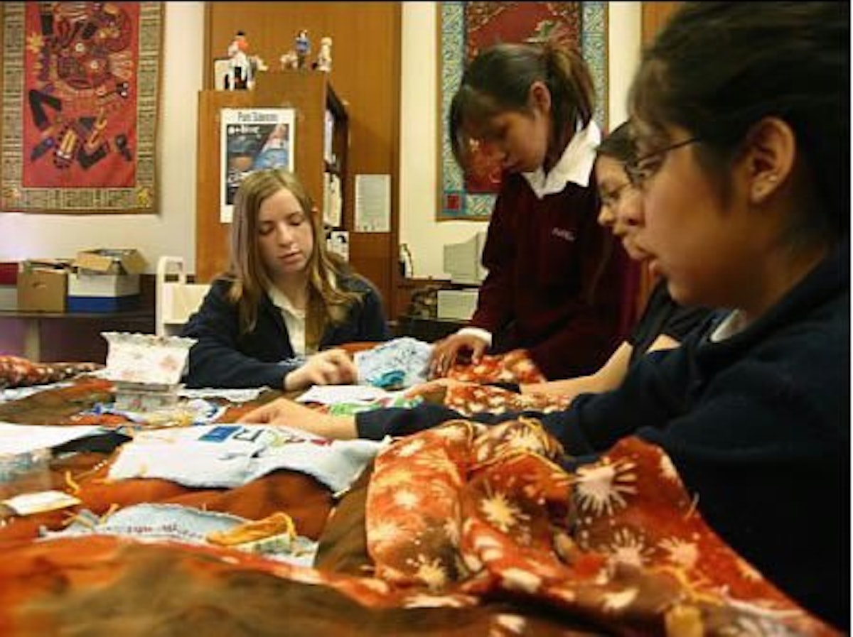 Students at Maxwell International School make a "virtue quilt" to be auctioned for charity.