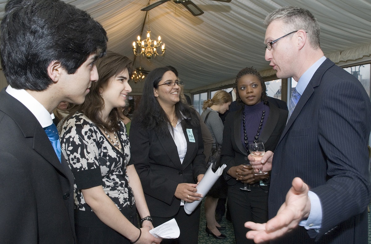 Member of Parliament Lembit Opik talks with four young speakers at the reception of the All Party Parliamentary Friends of the Baha'is group on 22 April 2008. From left are Collis Tahzib, Jenna Nicholas, Lavina Hassasing and Ruth Banda. Photograph: Andisheh Eslamboli.