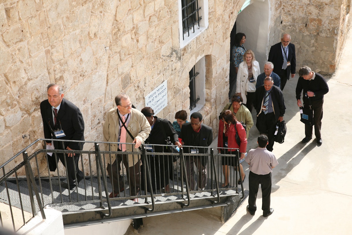 Delegates to the International Baha'i Convention ascend the stairs leading to the prison cell in the walled city of Acre where Baha'u'llah was incarcerated.