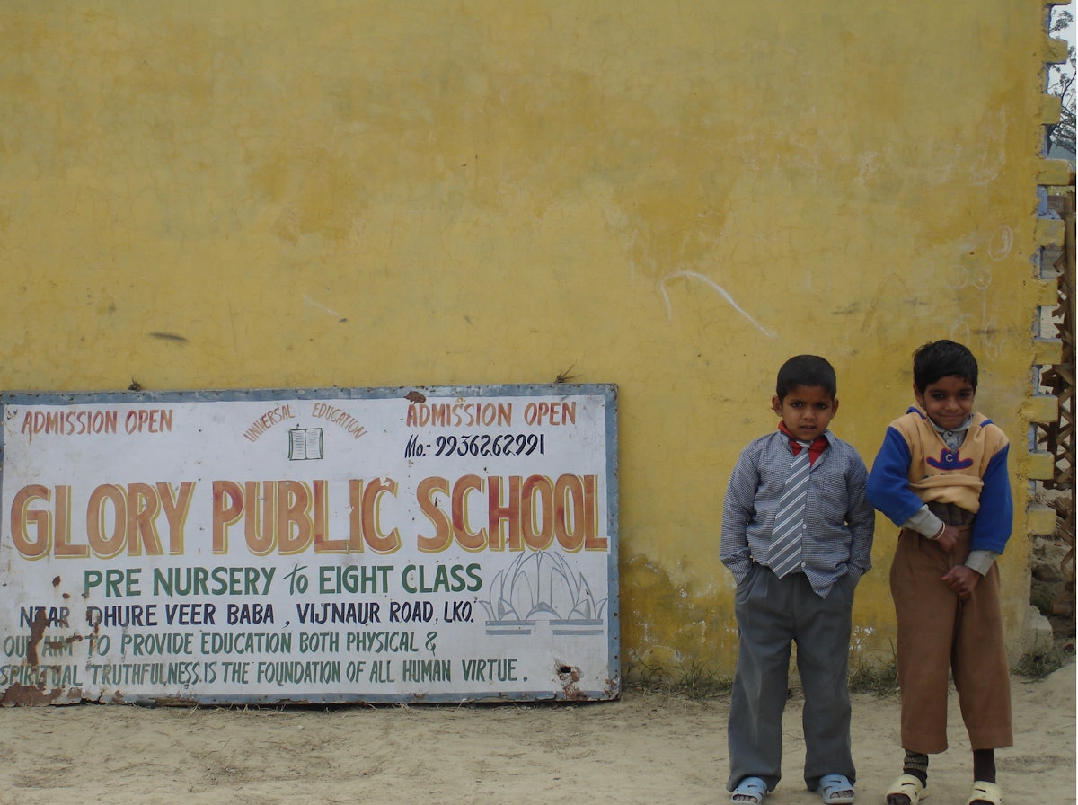 Two young pupils at Vinod Kumar Yadav's Glory Public School pose proudly for the camera.
