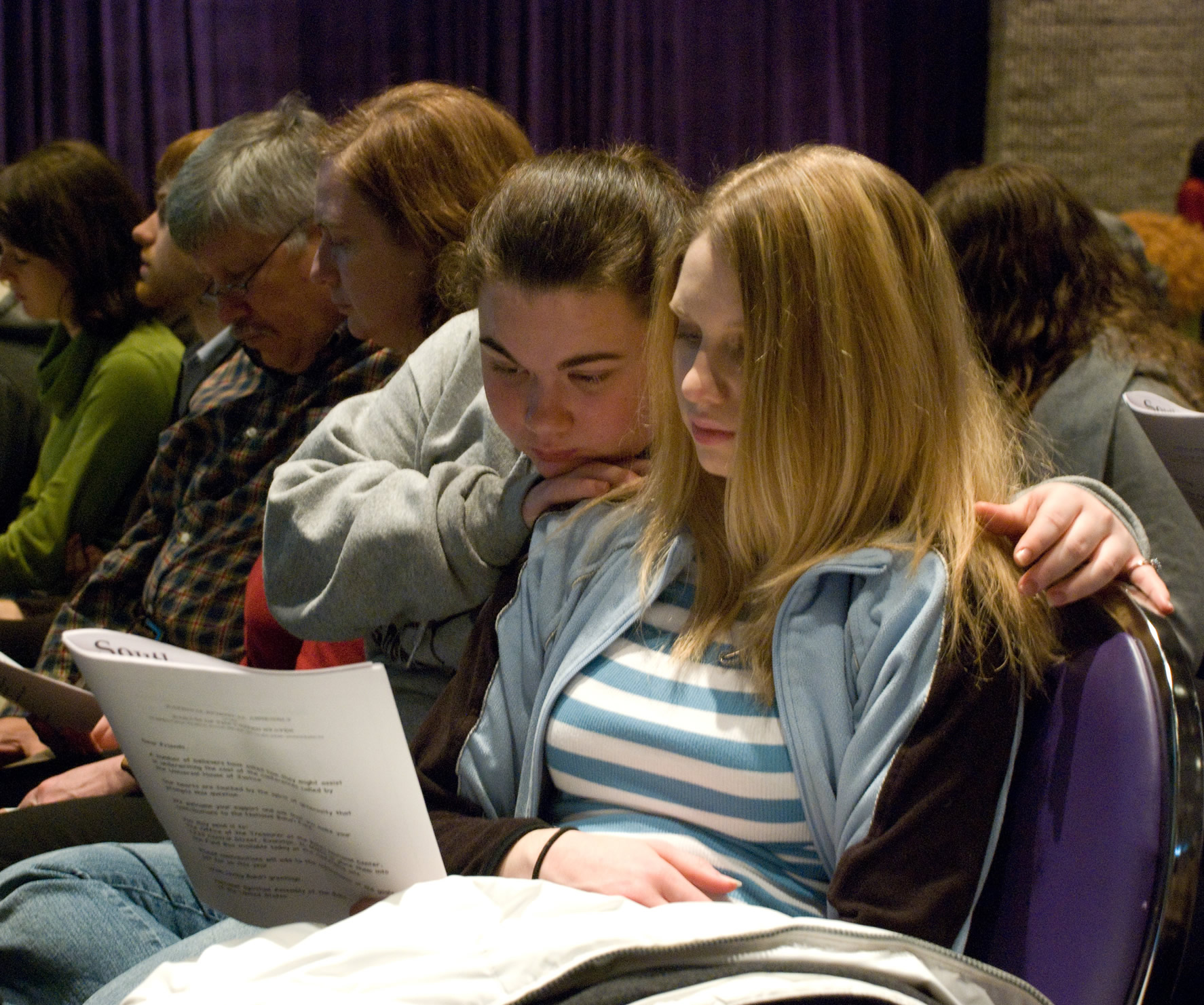 Participants in Atlanta study a letter from the Universal House of Justice.