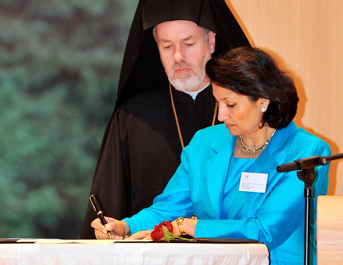 Baha’i representative Bani Dugal signs the 2008 Faith in Human Rights statement on 10 December at The Hague. Looking on is the Right Reverend Bishop Athenagoras (Peckstadt) of Sinope, of Belgium.