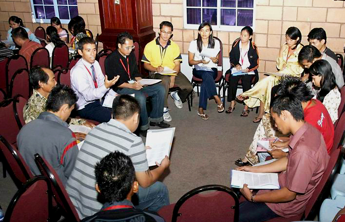 In Kuching, conference participants consult together in a workshop session.
