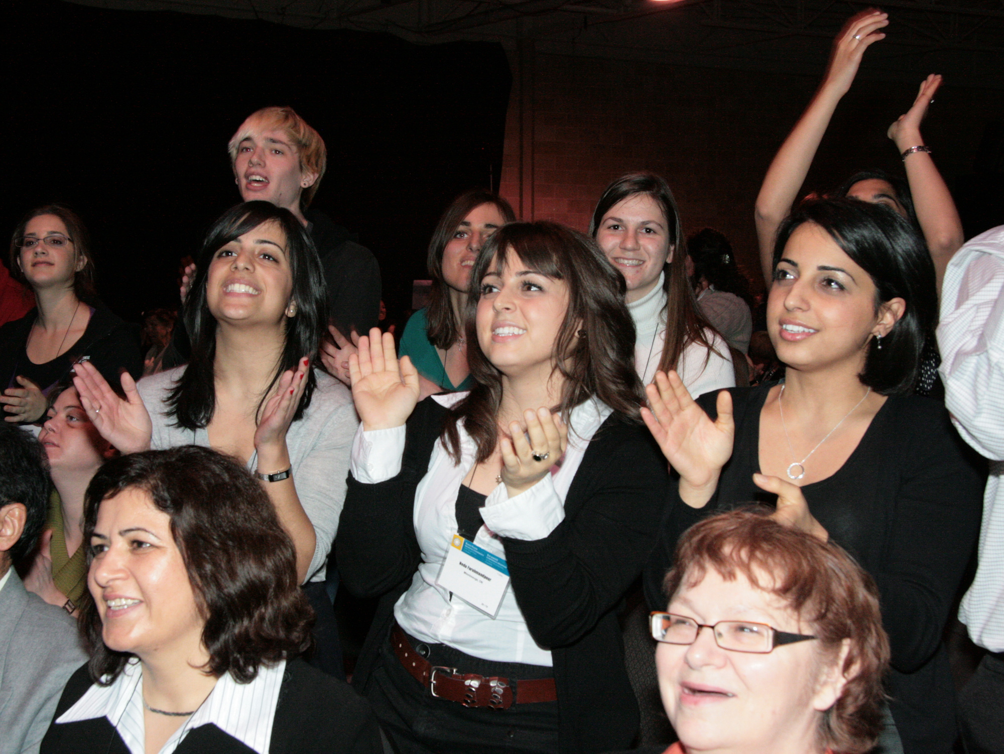 The conferences were called by the Universal House of Justice, partly to celebrate recent achievements in community-building activities. These young people are watching a cultural program at the Toronto gathering.