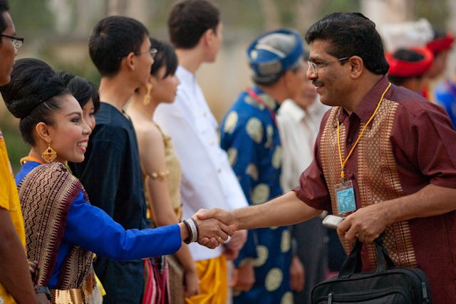 Greeters in traditional costumes from the participating countries of Cambodia, Laos, Thailand, and Vietnam welcome people arriving to the Baha'i conference in Battambang.