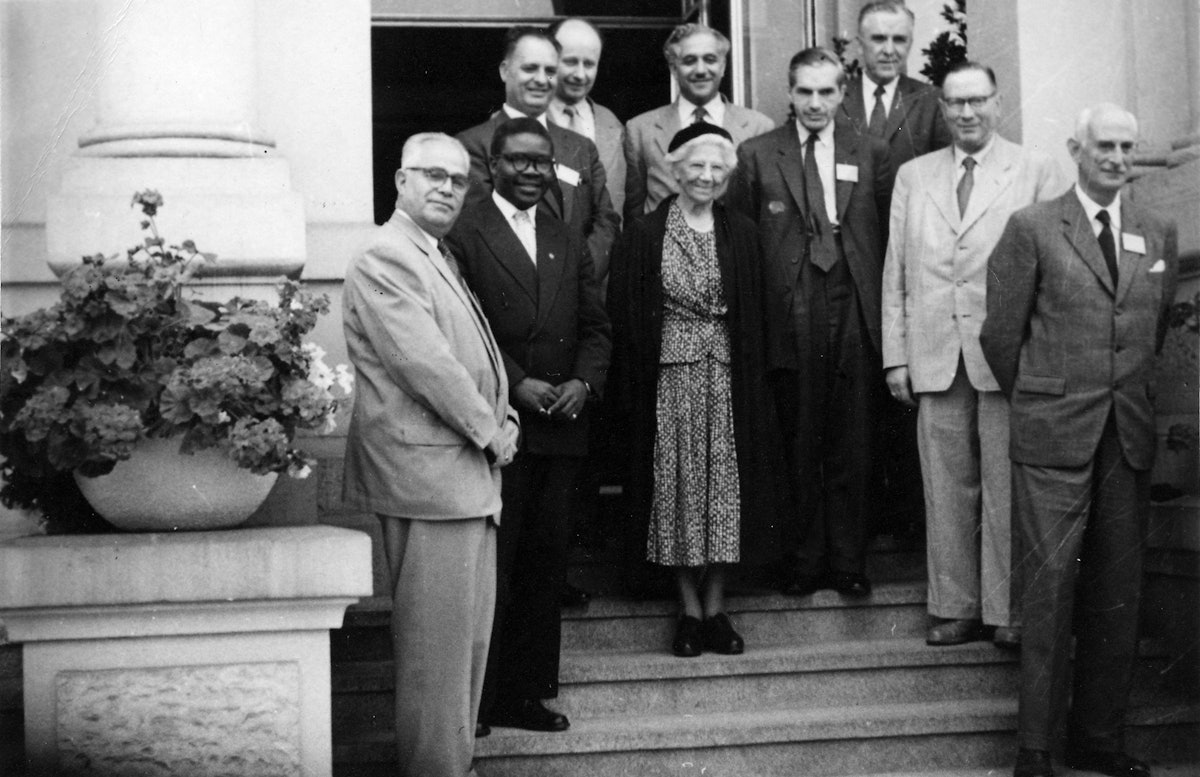 Amelia Collins, center, was the representative of the Guardian of the Baha'i Faith at the July 1958 gathering in Frankfurt. Other Hands of the Cause present, from left, were Jalal Khazeh, Enoch Olinga, Zikrullah Khadem, Adelbert Muhlschlegel, Hasan Balyuzi, John Ferraby, John Robarts, Hermann Grossmann, and Ugo Giachery. Also present but not pictured was Musa Banani. (Baha’i World Centre photograph)