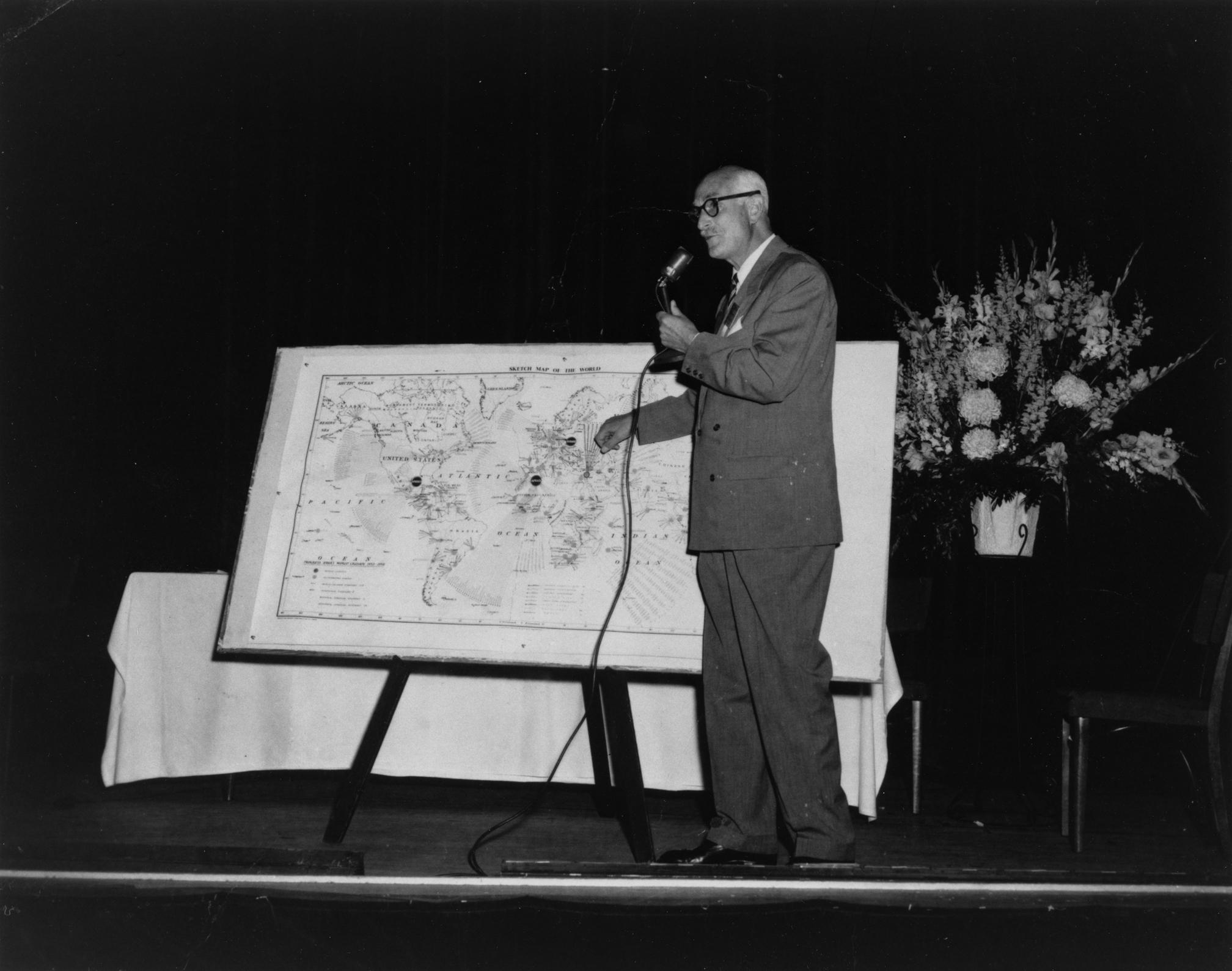 Dr. Ugo Giachery, the Guardian’s representative to the Chicago conference in May 1958, shows the map made by the Guardian to outline progress of the 10-year plan. (Baha’i World Centre photograph)