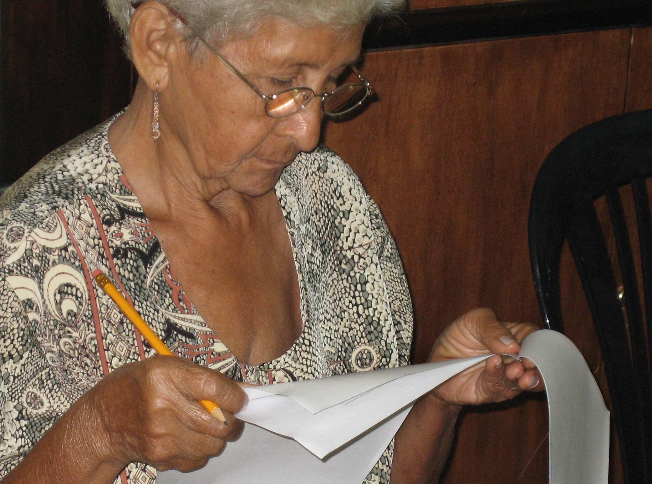 An individual in Maracaibo, Venezuela, thoughtfully considers her vote. In Baha'i balloting, there are no nominations and no discussion about whom to vote for.