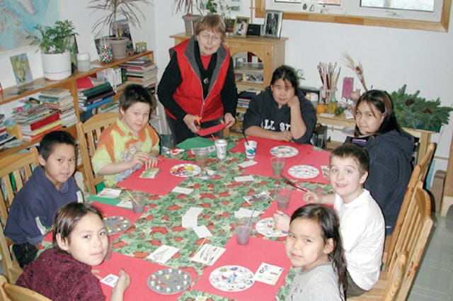 In this file photo from the Nunatsiaq News, Beth McKenty prepares materials for youngsters in Iqaluit who come her sessions to create art. (Photo copyright 2002 Nunatsiaq News. Used by permission.)