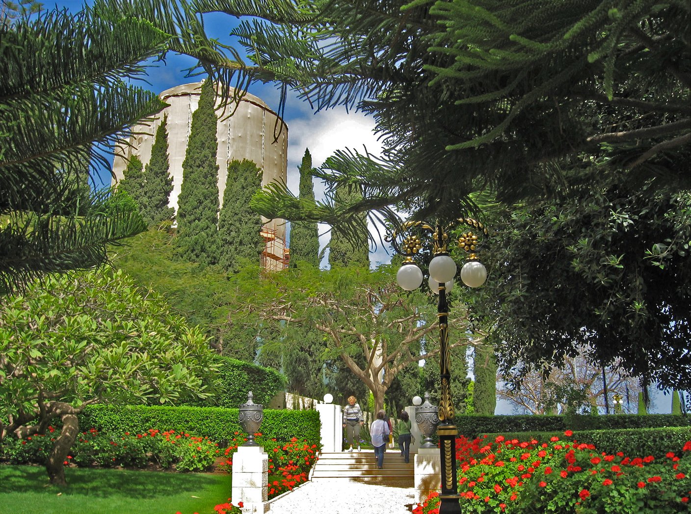 Although the exterior of the Shrine of the Bab is shrouded (shown in the background), visitors can still experience the peace and harmony of the gardens and can enter the burial chamber for prayer. Entry is suspended only during three summer months when Baha’i pilgrims are not present. (BWNS photo)