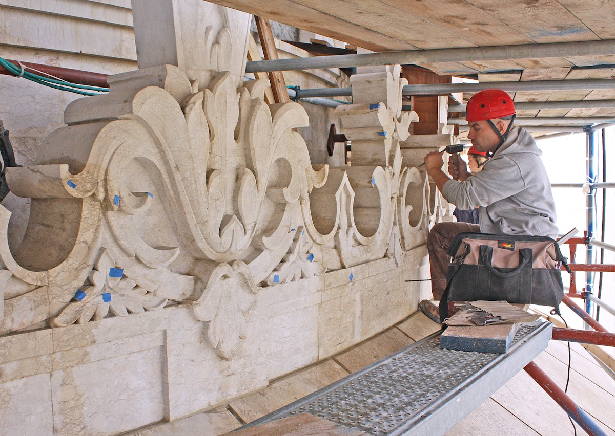 Workers are going over the entire stone exterior of the shrine and repairing every spot that shows signs of damage from 50 years of exposure to the elements. Jubin Nakhai, shown here, is an experienced stone carver from Canada. (Baha’i World Centre photo. All rights reserved.)