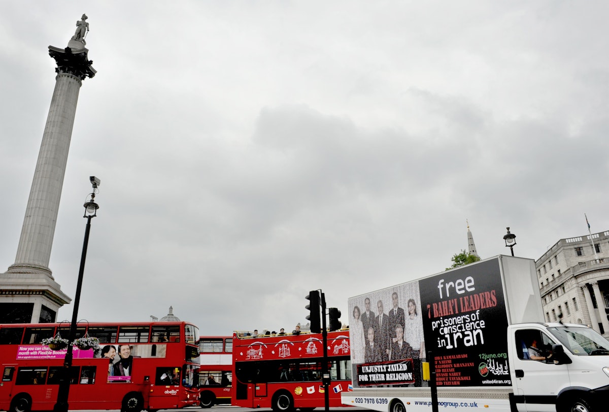The mobile billboard depicting the seven imprisoned Baha'i leaders is driven through Trafalgar Square in London, England.