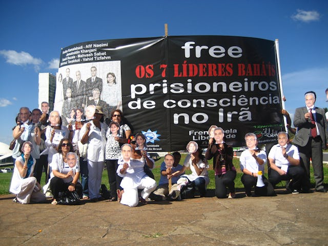 In Brazil, human rights campaigners carrying masks depicting Iran's seven Baha'i leaders gathered in front of the Brazilian National Congress, Brasilia.