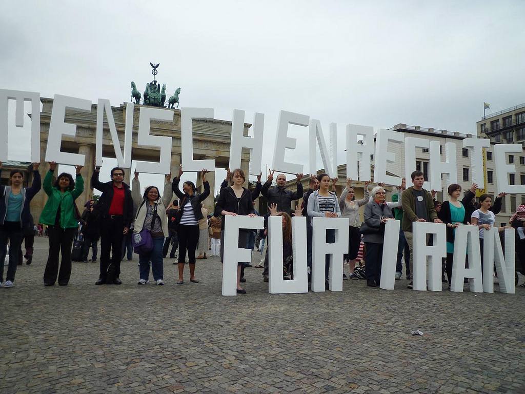 The slogan "Human rights for Iran" is displayed in large letters by campaigners gathered at Berlin's Brandenburg Gate.