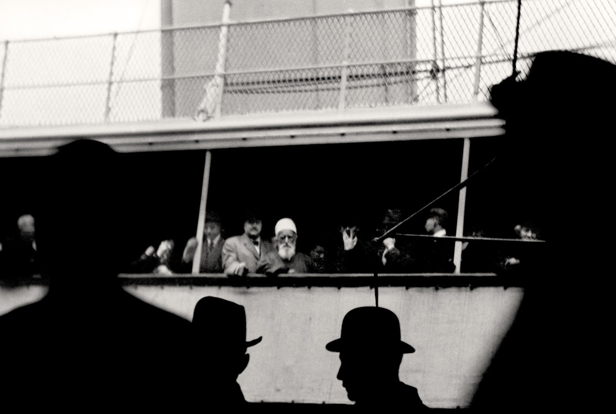 'Abdu'l-Baha glimpsed on board the S.S. Celtic as He sailed away from New York City bound for Liverpool, England, 5 December 1912. His parting words expressed the wish "that the East and West may embrace each other in love and deal with one another in sympathy and affection. Until man reaches this high station, the world of humanity shall not find rest..."