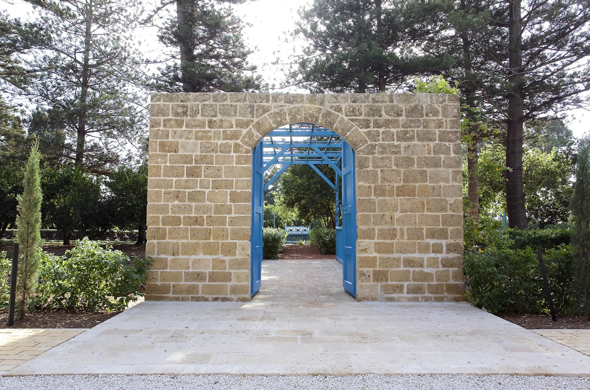 Visitors to the Ridvan Garden now enter through this simple gateway and across a blue, stainless steel bridge.