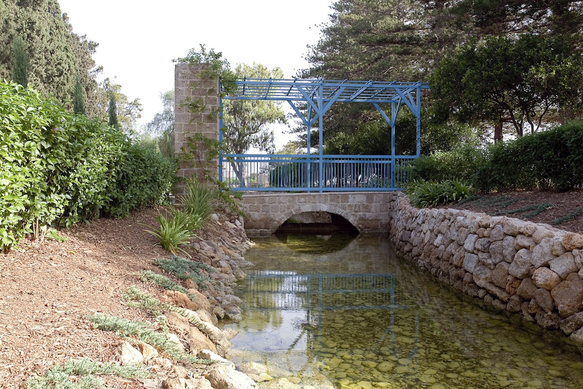 The restoration work has reinstated a bridge as an entrance to the Ridvan Garden. The original wooden bridge has been replicated exactly in stainless steel, painted blue. A weir has been created beneath the bridge to enhance the sound and movement of water as it flows south towards the flour mills. "The restoration has brought about a radical change in the atmosphere of the place," says Albert Lincoln, Secretary General of the Baha'i International Community.