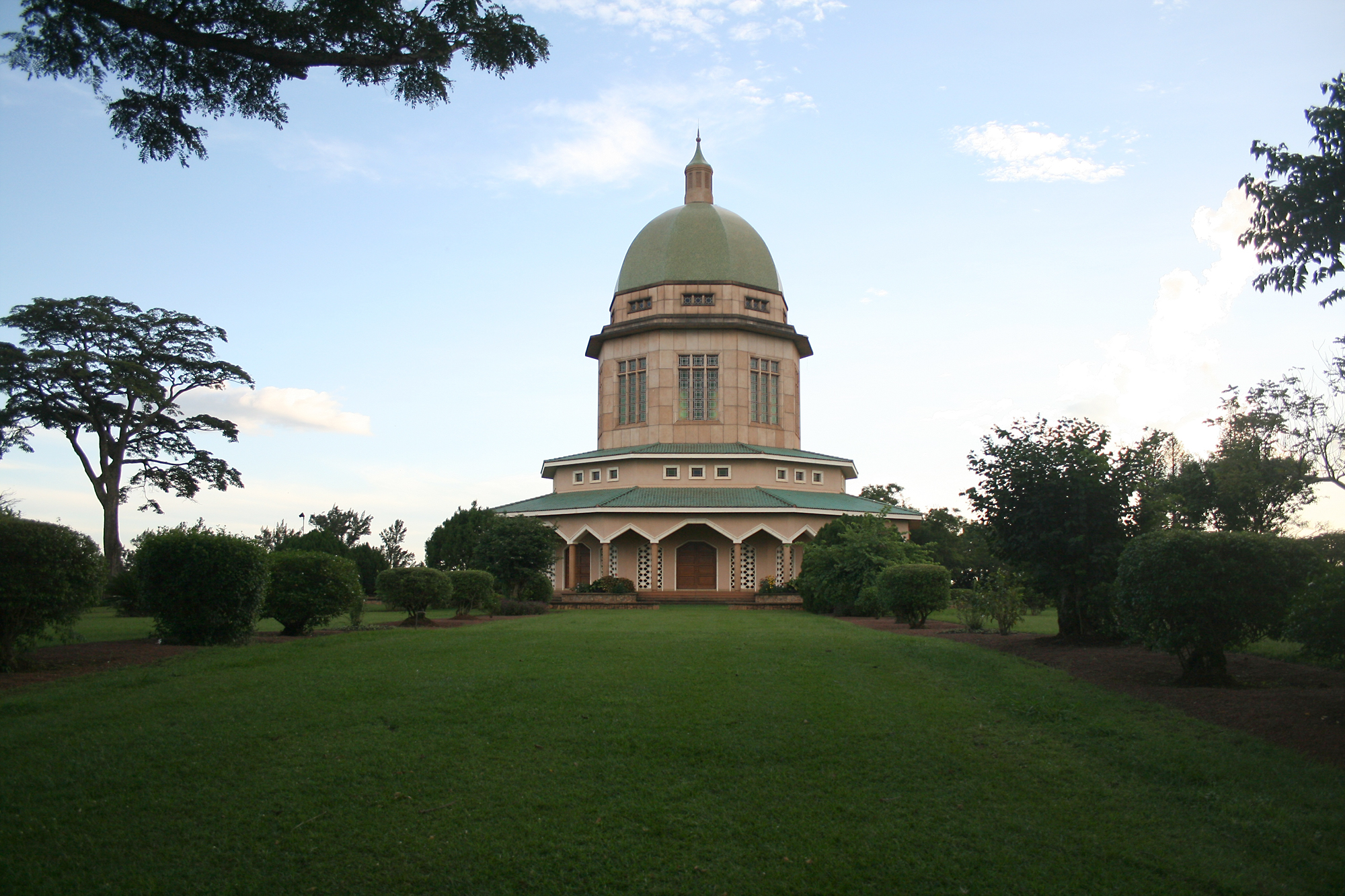 Numerous species of trees and vegetation thrive in the gardens around the Baha'i House of Worship in Kampala, including mahogany and teak trees, as well as eucalyptus and bamboo which play a role in combating global warming. The extensive grounds, taking up almost 50 acres, are a major attraction for the people of Kampala. Uganda's Chief Justice the Honorable Mr. Justice Benjamin J. Odoki thanked the Baha'i community for maintaining the gardens. "They are very beautiful," he said, "and they represent the spiritual purity to unite the world."