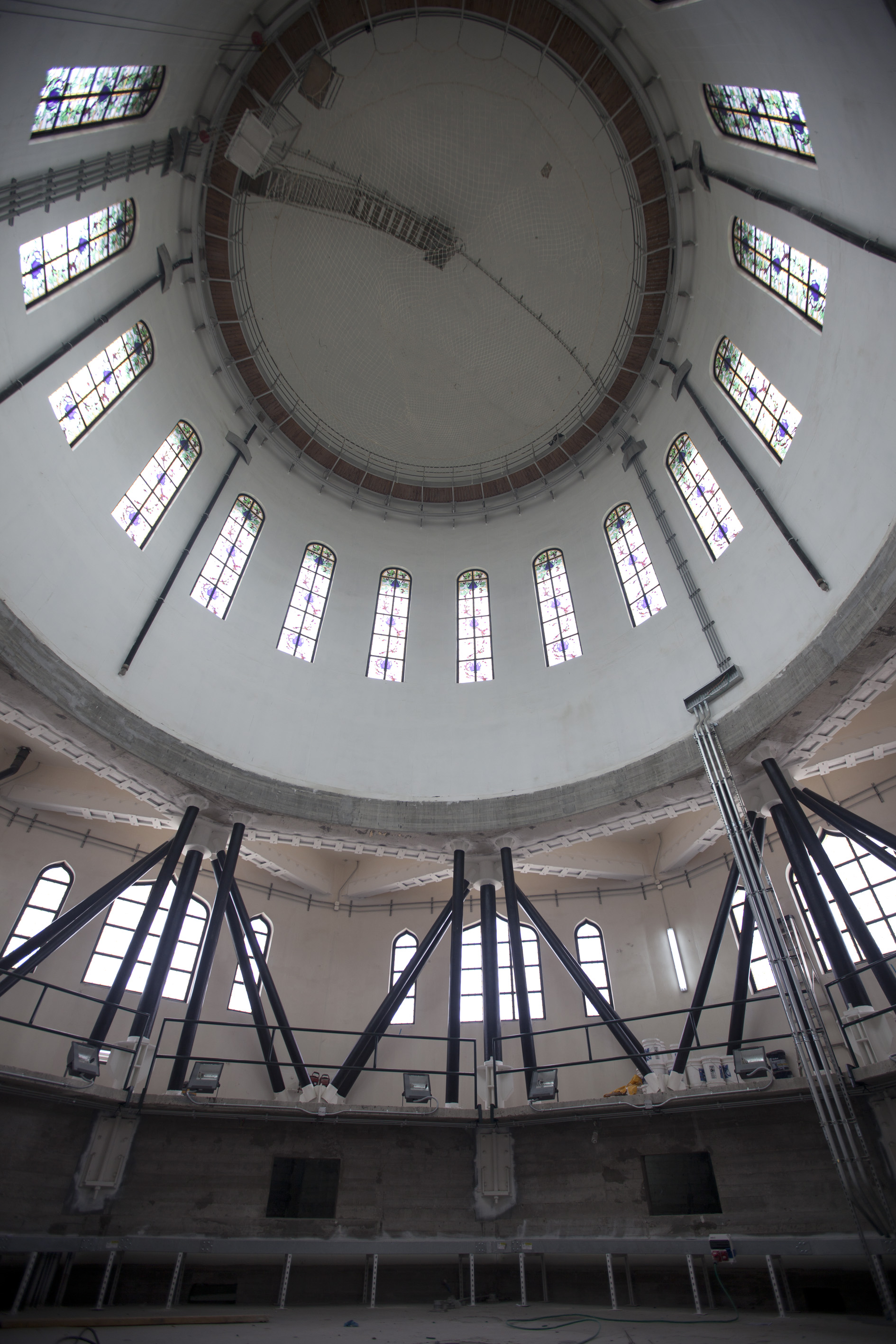 An interior view of the drum of the Shrine of the Bab, showing elements of the new structure designed to strengthen the building against earthquakes. New heavy steel bracings connect the reinforced ringbeam to the original concrete piers of the superstructure. Photo credit: Baha’i World Centre photo. All rights reserved.