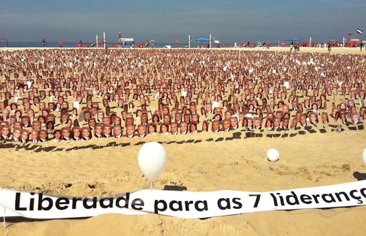 Almost 8,000 images depicting the faces of Iran's seven imprisoned Baha'i leaders arranged on Rio's Copacabana Beach, 19 June 2011. The banner in front reads, "Liberation for the 7 leaders".