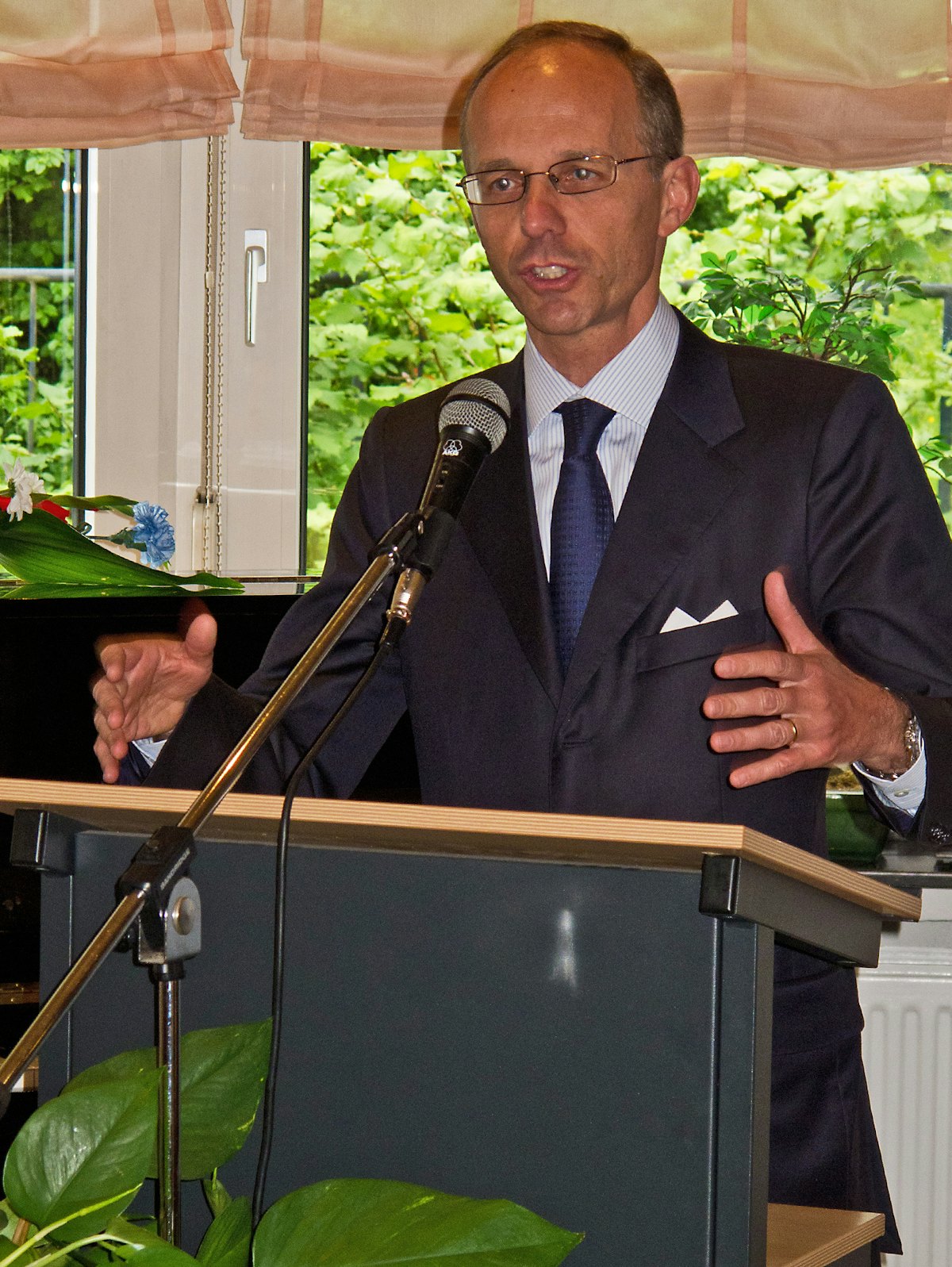 Luxembourg's Minister of Finance, Luc Frieden, addressing a celebration marking National Day at the Baha'i Centre in Luxembourg City.