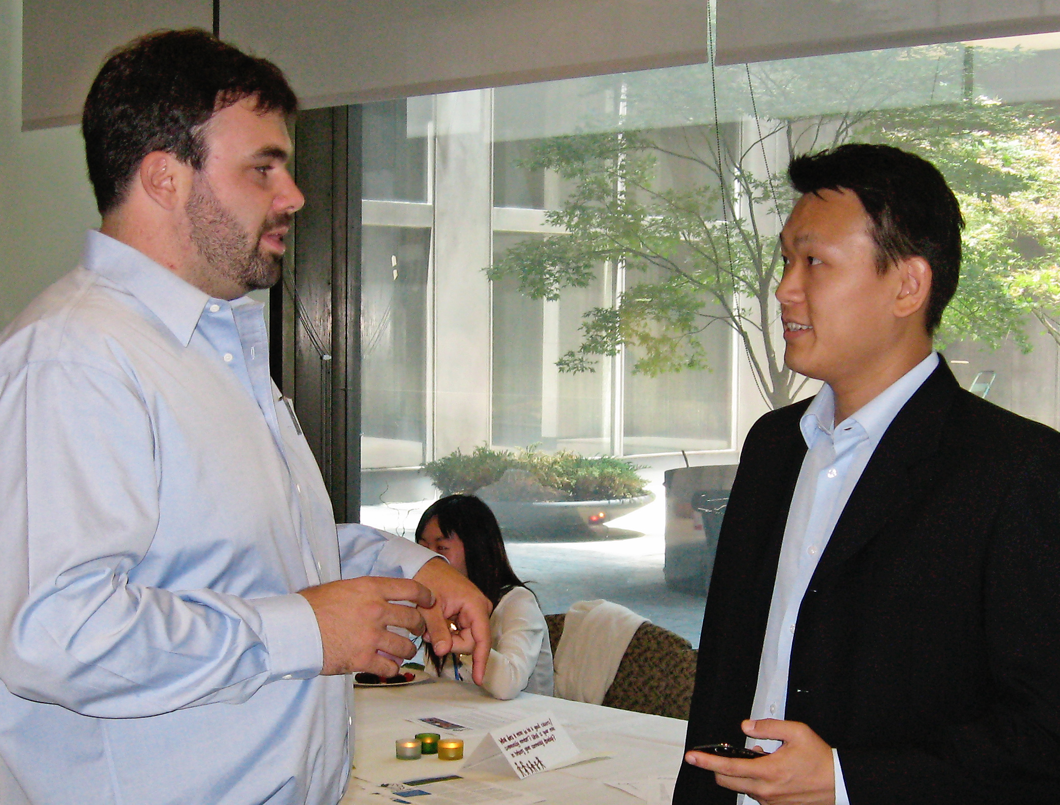 Nathan Forster of Alas de Rio, left, and Ming Hwee Chong of the Bahá'í International Community, talk during a workshop session titled "Our Voices, Our Aspirations: A Youth Dialogue on Sustainable Development." Held on Tuesday at the offices of the Bahá'í International Community.