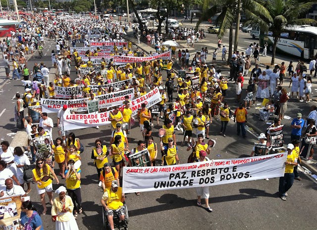 25,000 marchers took part in Rio's Religious Freedom Walk on 18 September 2011. Brazilian Baha'is are seen here carrying a banner which reads, "Peace, Respect and Unity of Peoples." 1,000 yellow vests bearing the slogan, "Today, we are followers of all religions" were distributed and worn by people of all faiths at the rally.